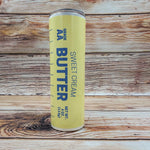 Tumbler resembling sweet cream butter sitting on a wooden background