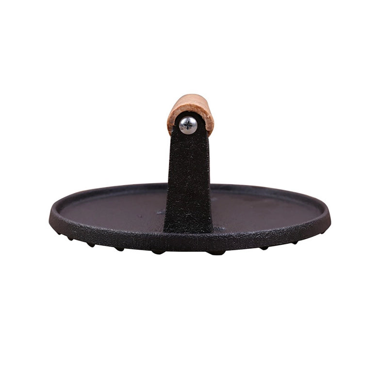 Cast iron burger press with wooden handle on a white background