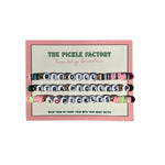 Set of friendship bracelets with letter beads in a 'The Pickle Factory' branded box.