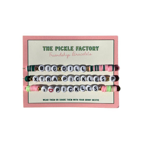 Set of friendship bracelets with letter beads in a 'The Pickle Factory' branded box.