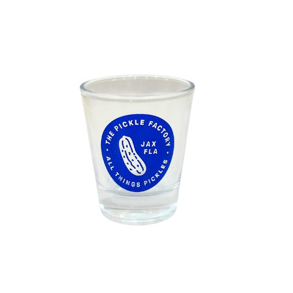 Clear shot glass with blue 'The Pickle Factory' logo