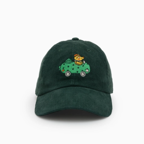 Green cap with embroidered design on a white background