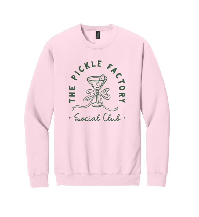 Pink sweatshirt with 'The Pickle Factory Social Club' text and pickle graphic on a white background