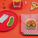 Food-themed tableware displayed on a red table