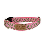 Pink dog collar with a pickle pattern on a white background