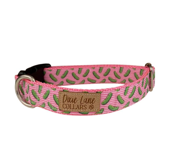 Pink dog collar with a pickle pattern on a white background