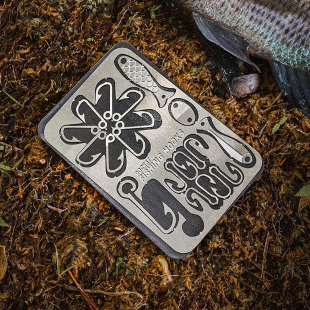 Fishing hook tool kit atop moss.