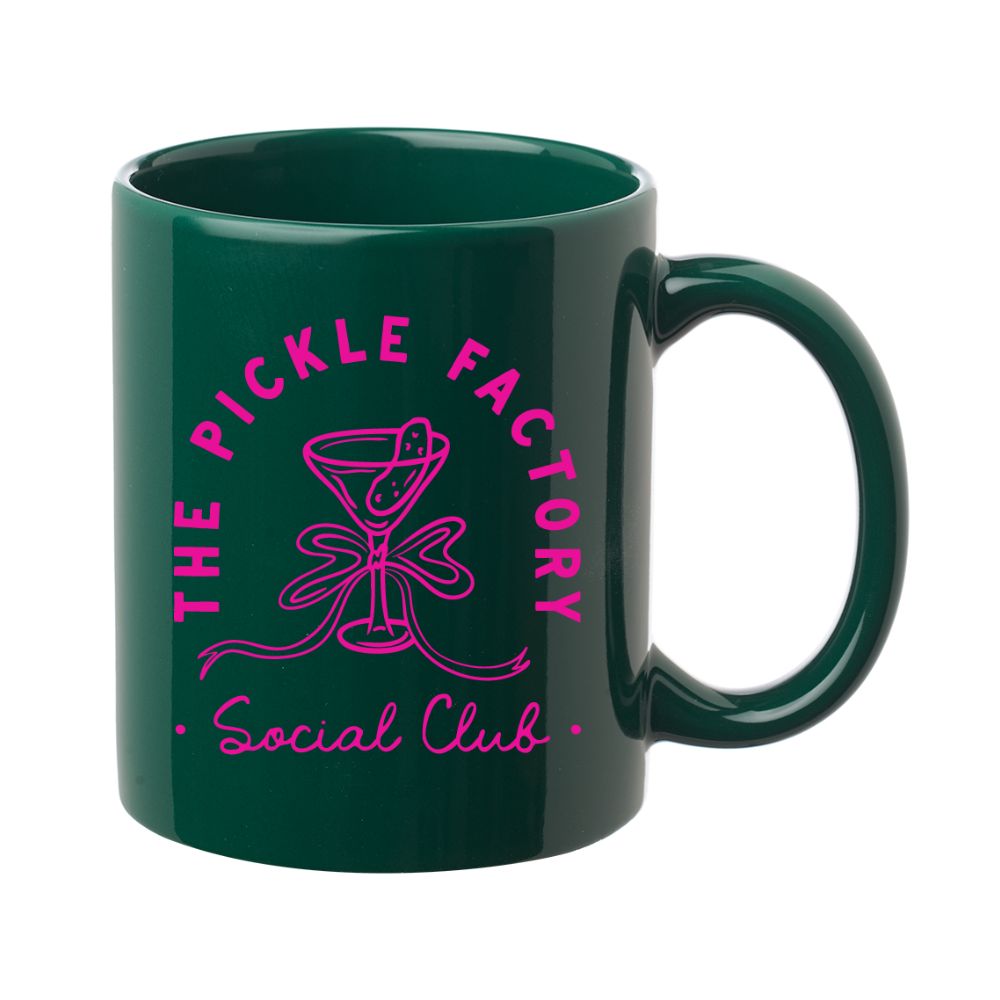 Green mug with pink 'The Pickle Factory Social Club' text and design on a white background