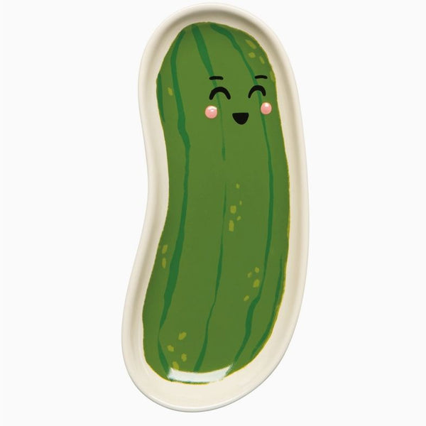Green pickle-shaped plate with a smiling face on a white background