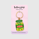 Enamel keychain of a pickle jar on a pink backer card with 'brittany paige' vendor branding.